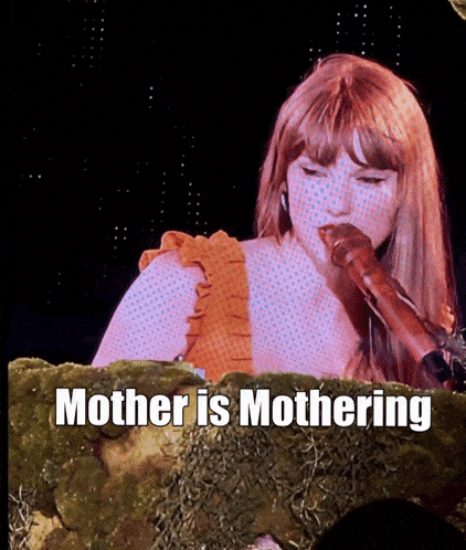 a woman singing into a microphone with the words mother is mothering on the bottom
