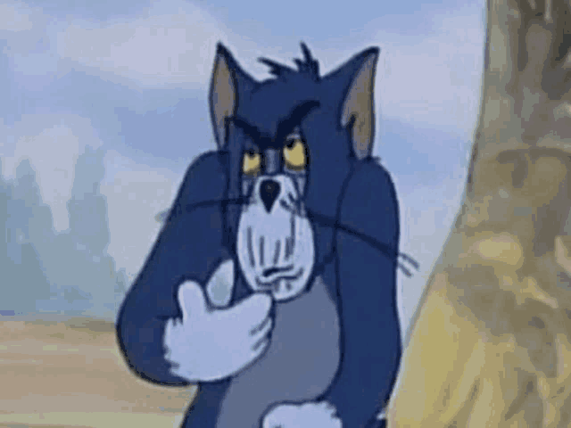 a cartoon cat is standing next to a tree and covering his face with his hand .