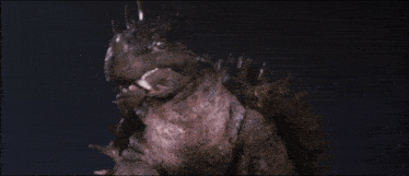 a statue of a monster with spikes on it 's body