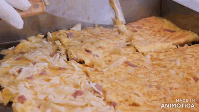 a pizza is being made in a pan with the words made in animatica on the bottom