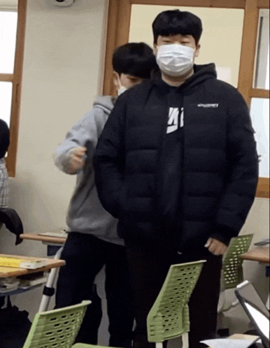 a man wearing a mask and a discovery jacket