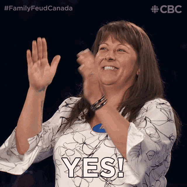 a woman applauds and says yes in front of a cbs logo