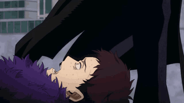 a person with purple hair is laying on their back
