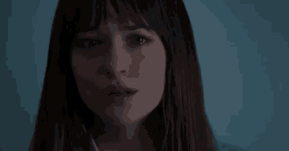 a close up of a woman 's face with tears running down her face .