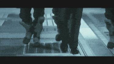 a person 's feet are shown in a blurry photo as they walk down stairs