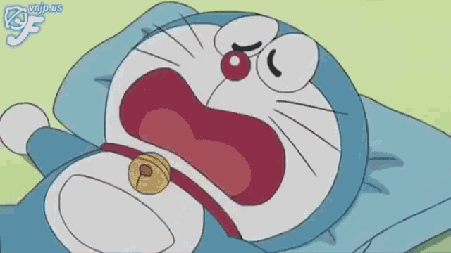 a cartoon of doraemon laying on a pillow with a bell around his neck