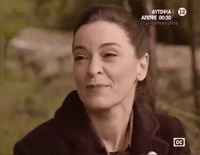 a close up of a woman 's face on a tv screen with cc written on the bottom right