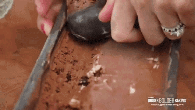 a woman is scooping ice cream out of a loaf pan .