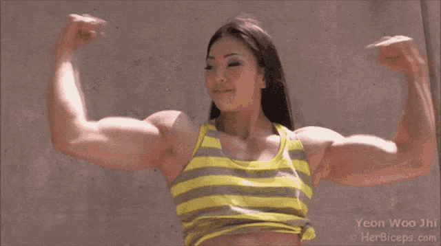 a woman in a yellow and grey striped tank top is flexing her muscles ..