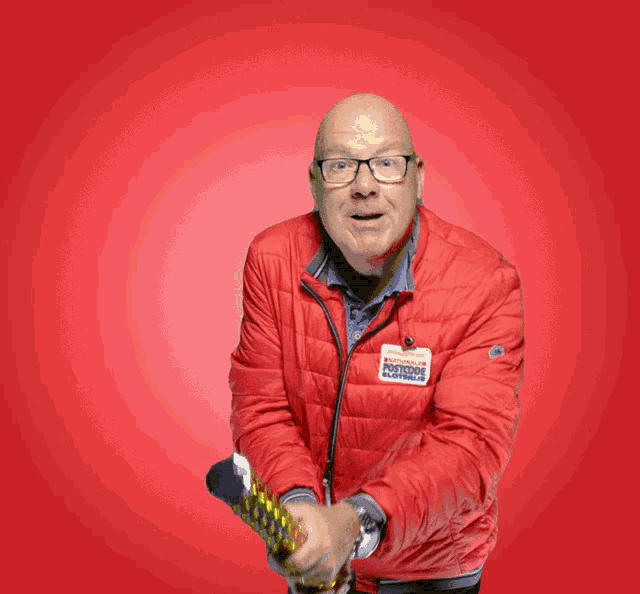 a man wearing a red jacket that says ' bomber ' on it