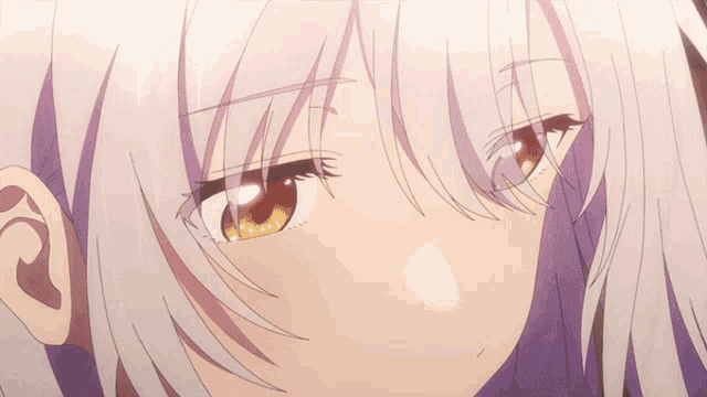 a close up of a girl 's face with gray hair and yellow eyes