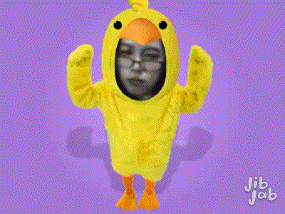 a person is wearing a yellow chicken costume with their face in it
