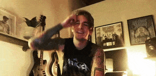 a man in a metallica shirt is standing in a room