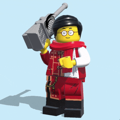 a lego figure is holding a cellphone in his hand