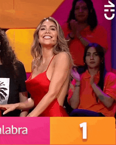 a woman in a red dress is standing in front of a sign that says labra