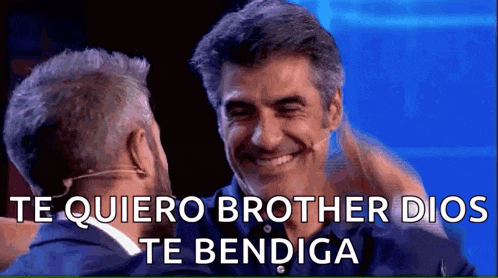 two men are hugging each other and the words te quiero brother dios te bendiga are on the screen .