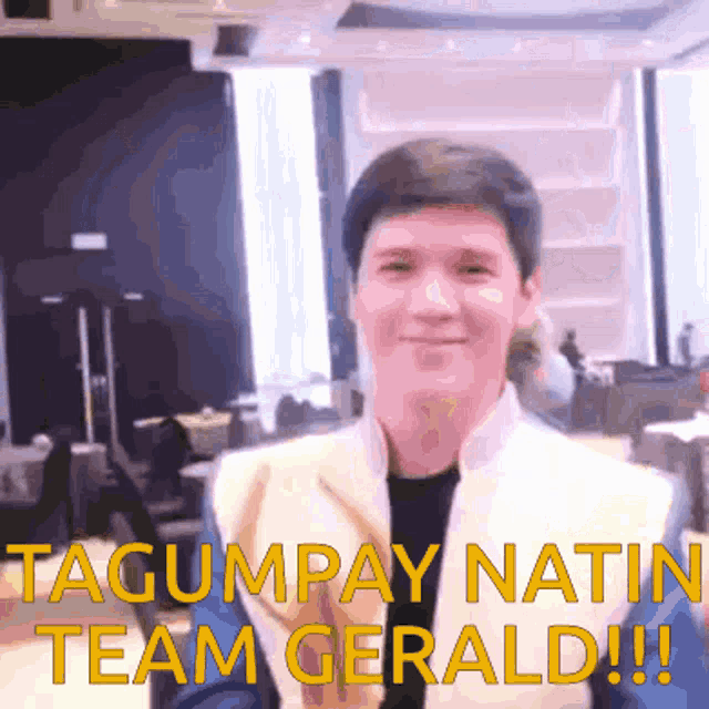 a man in a yellow jacket with the words tagumpay natin team gerald written on the bottom