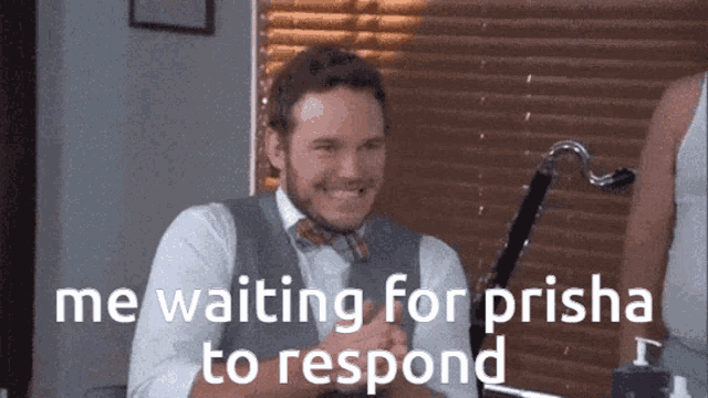 a man in a suit and bow tie is smiling and waiting for prisma to respond