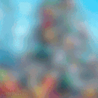 a blurry picture of a christmas tree with gifts under it