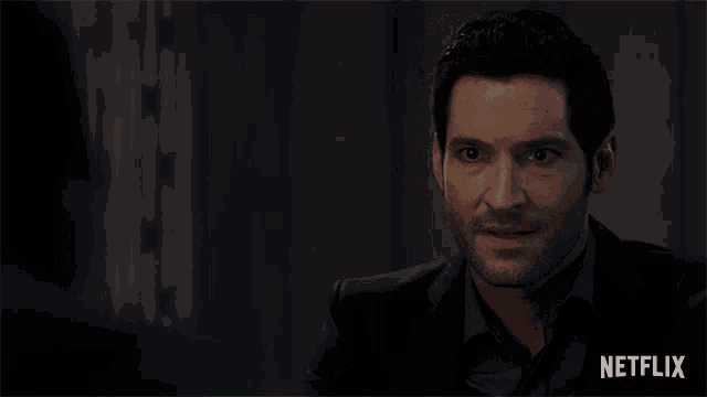 a man in a suit talks to another man with netflix written on the bottom