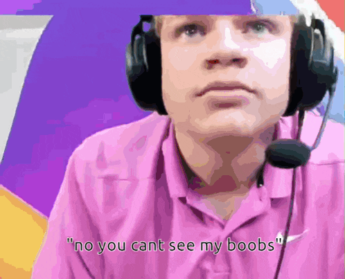 a man wearing a pink shirt and headphones says " no you cant see my boobs "