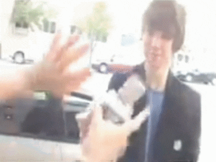 a blurry picture of a man being interviewed by a reporter
