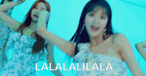 a woman in a white dress is dancing in front of a blue background that says lalalalilla