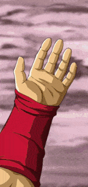 a hand with a red wristband is reaching up towards the sky