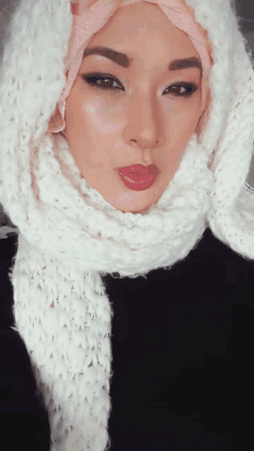 a woman wearing a hijab and a white scarf