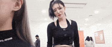 a woman in a black shirt with the word blood on the back
