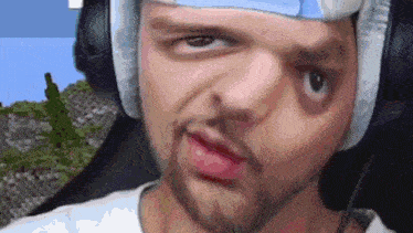 a man with a bandage on his head is wearing headphones and making a funny face