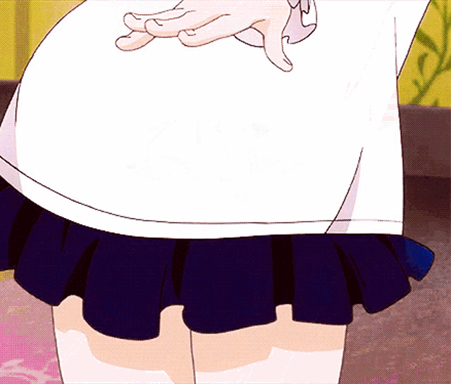 a girl in a white shirt and blue skirt crosses her fingers