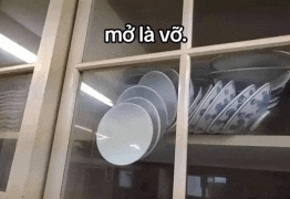 a stack of plates and bowls in a glass cabinet with the words mo la vo written on the glass