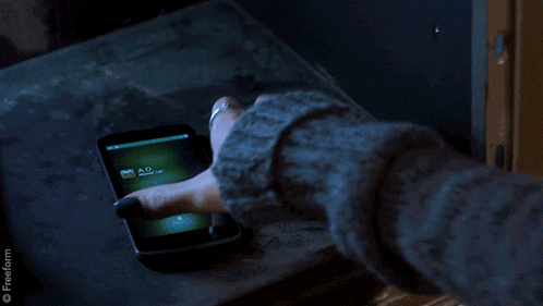 a woman is holding a cell phone with an ad message on it