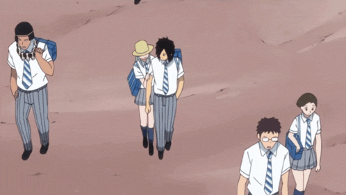 a group of people in school uniforms and ties are walking on a dirt road