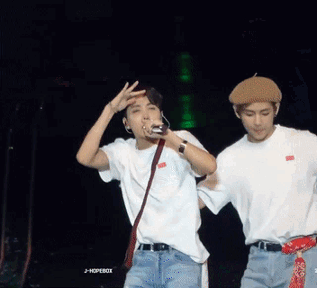 two men on a stage with j hopebox written on the bottom right corner