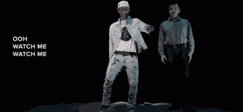 two men are dancing with the words ooh watch me watch me on the bottom right