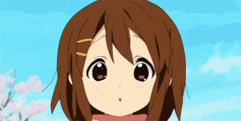 a close up of a girl 's face with a blue sky in the background .