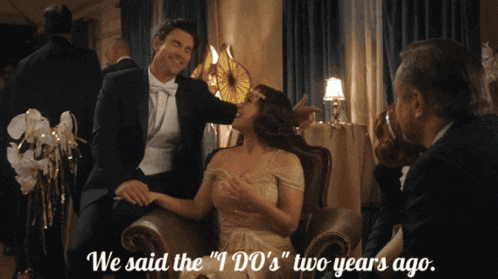a man and woman sitting in a chair with the words we said the " i do 's " two years ago on the bottom