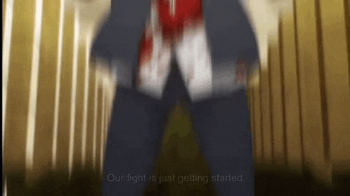 a blurry picture of a man in a suit with blood on his shirt .