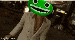 a man in a white suit is wearing a green headband with a face on it .