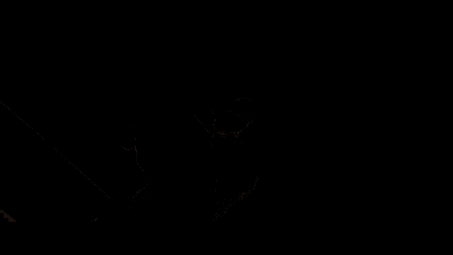 a silhouette of a man in a suit and tie standing in the dark