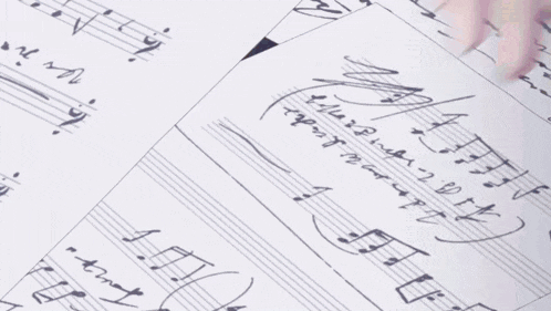 a person is playing a musical instrument with their fingers on a piece of sheet music .
