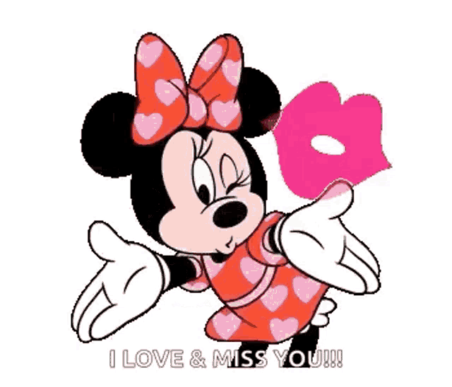 minnie mouse is wearing a red dress with hearts on it and a pink heart on her head .
