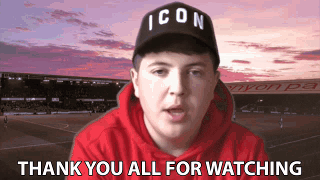 a man wearing an icon hat says thank you all for watching in front of a soccer field