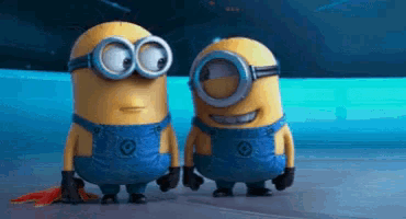 two minions are standing next to each other and smiling