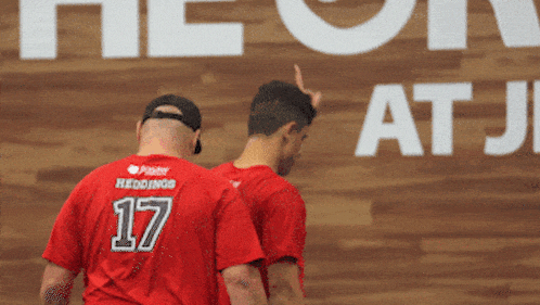 a man wearing a red shirt with the number 17 on the back