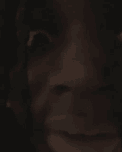 a close up of a person 's face with a blurred background
