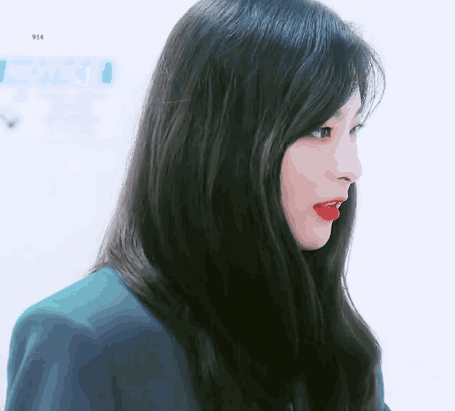 a close up of a woman 's face with the number 914 visible