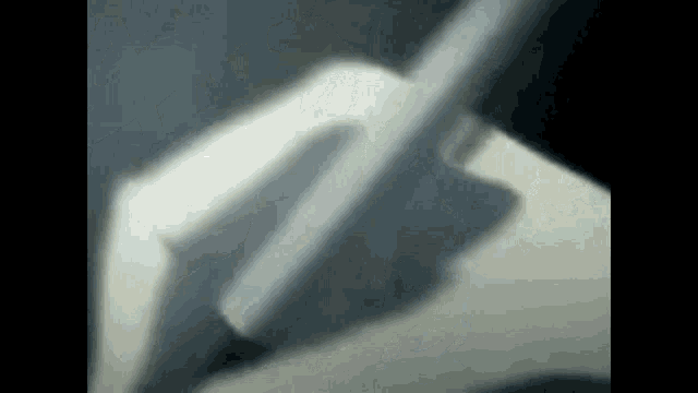 a close up of a person 's shadow on a white surface
